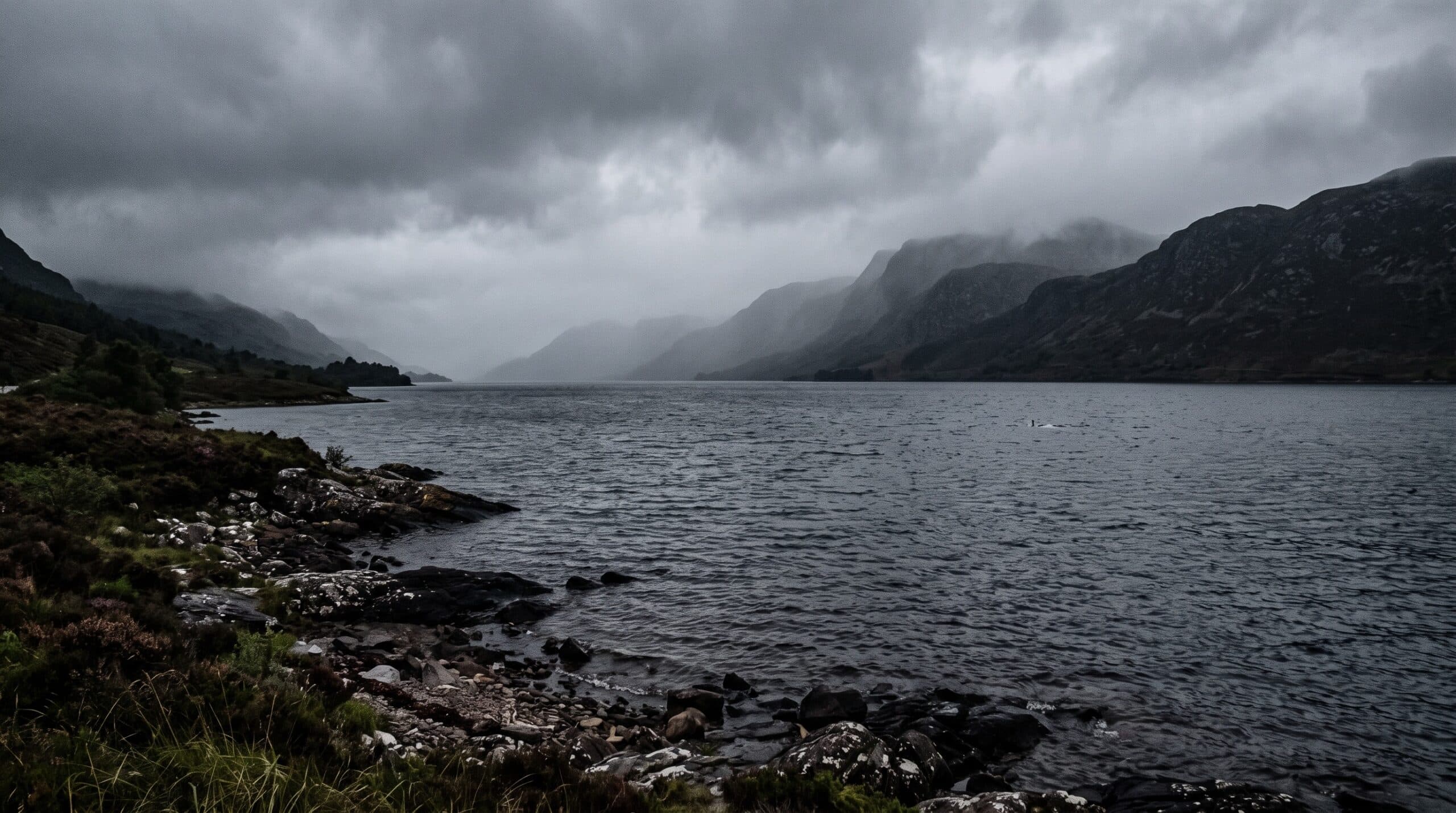 Misty Loch Ness with an ambiguous disturbance on the distant water